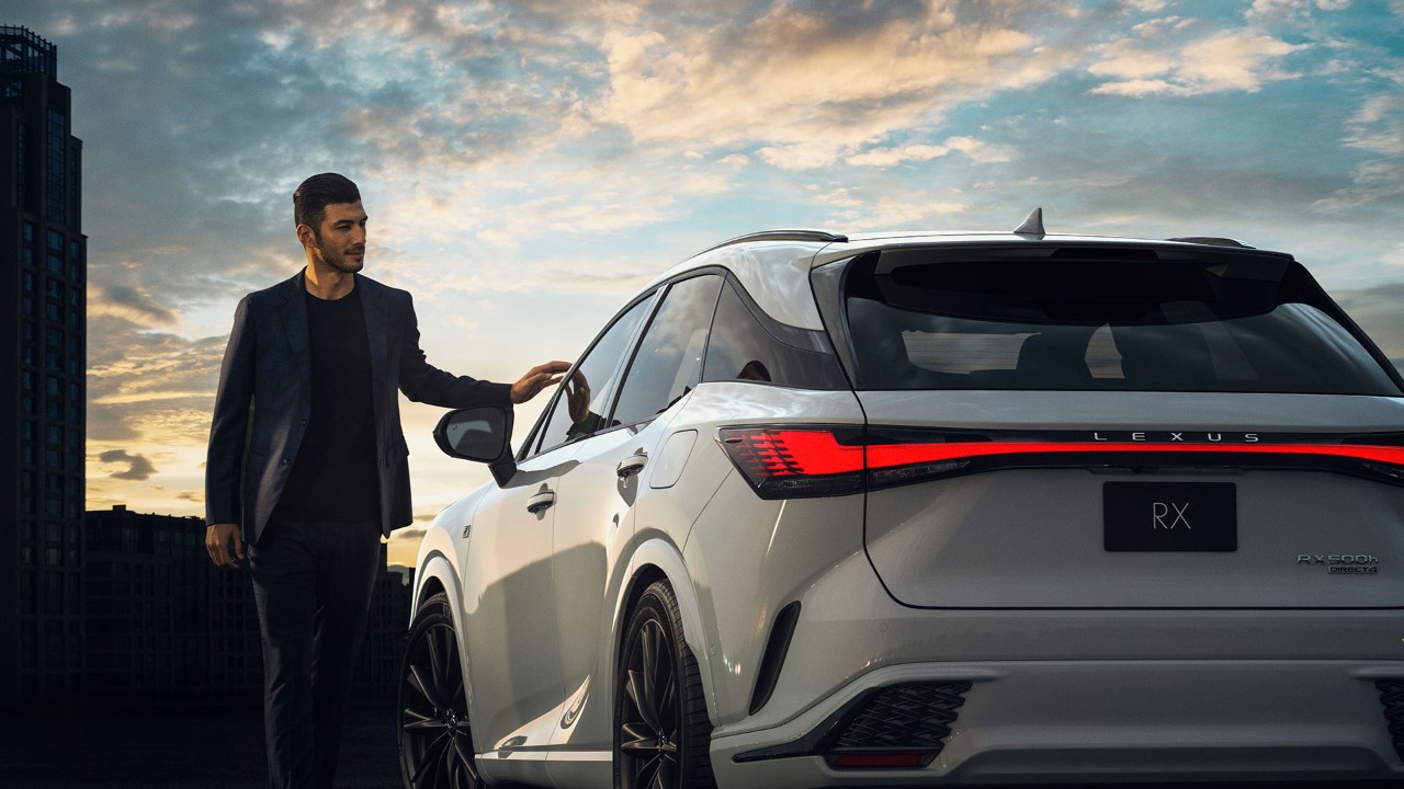 A man stood next to a Lexus RX