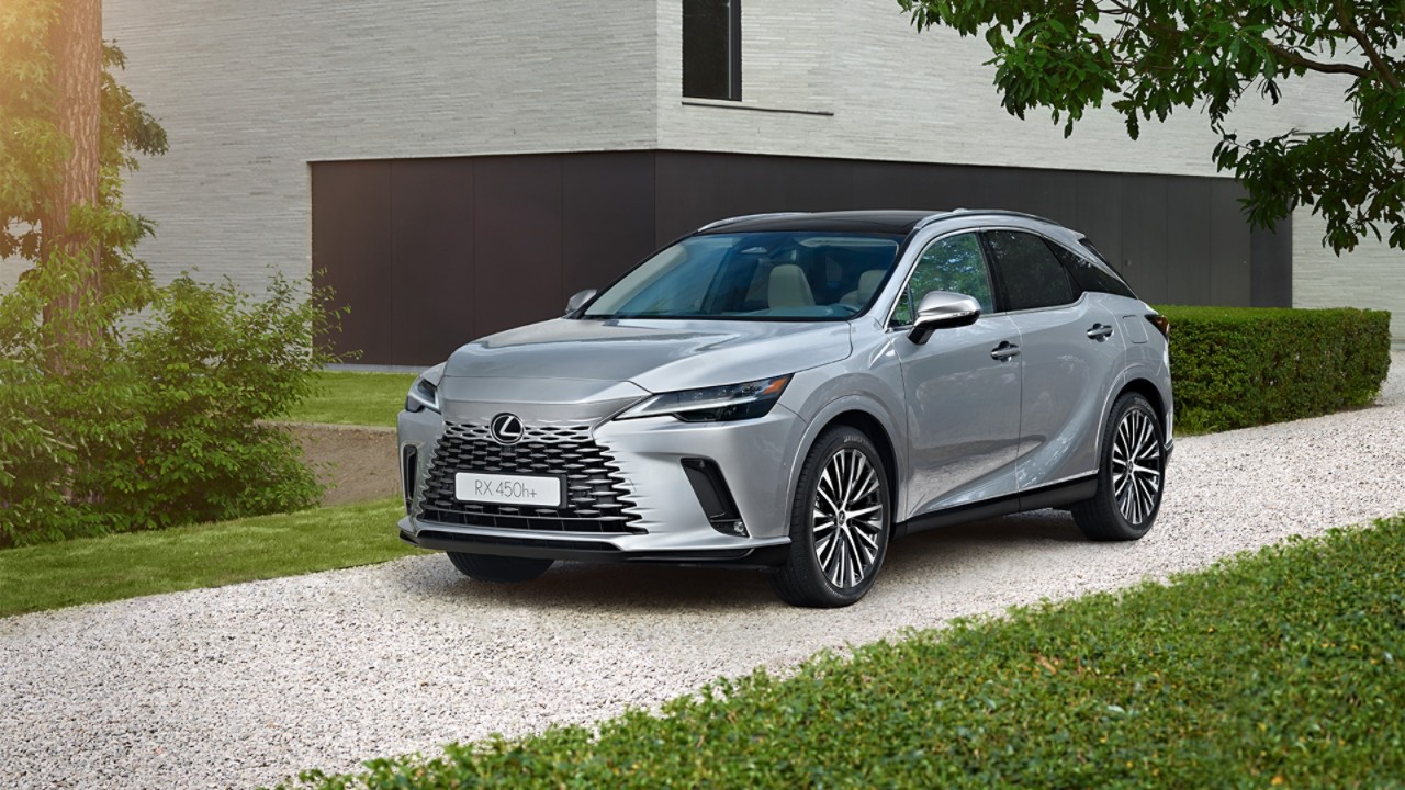 A Lexus RX 450h+ parked outside a building