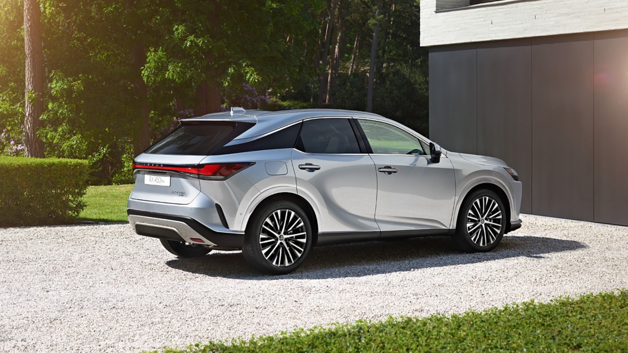 A Lexus RX 450h+ parked outside a building