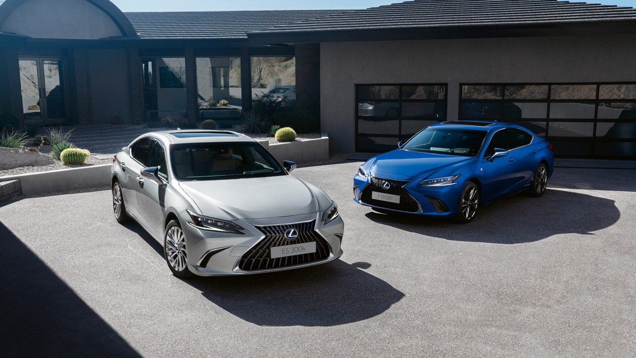 A Lexus ES 300h and Lexus ES F Sport parked outside a house 