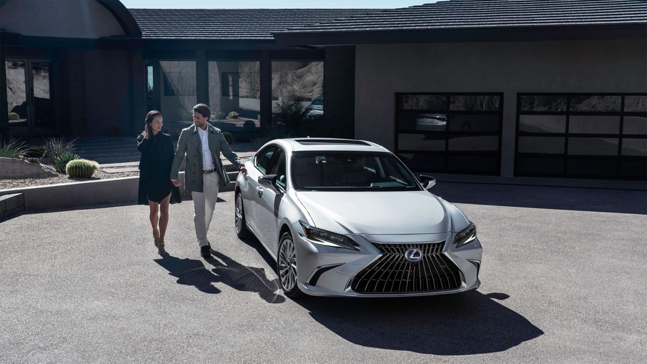 A man and woman approaching a Lexus ES 
