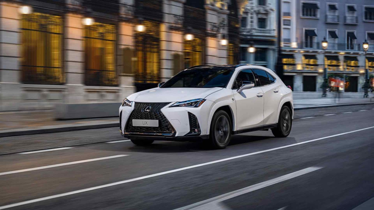 The Lexus UX driving in a town location