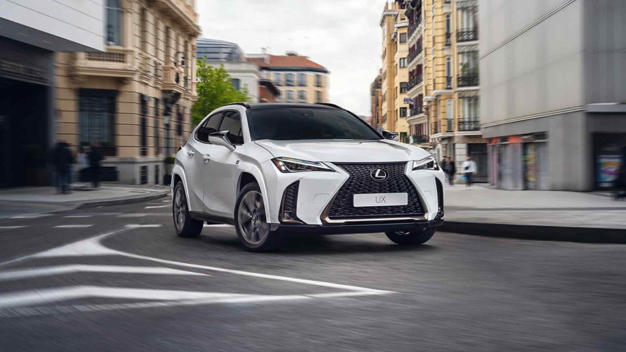 The Lexus UX driving in a town location