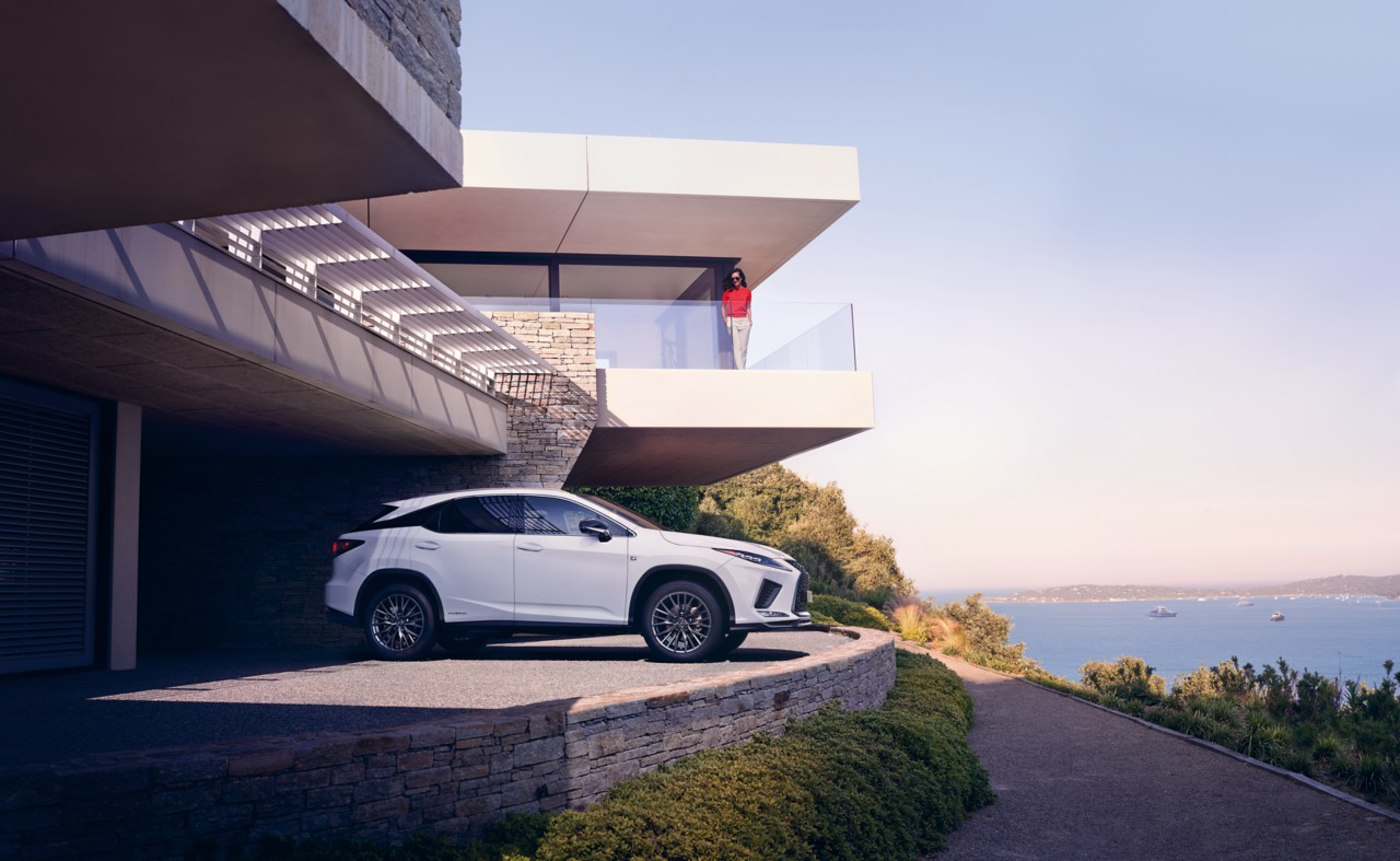 A Lexus parked at a water front house 