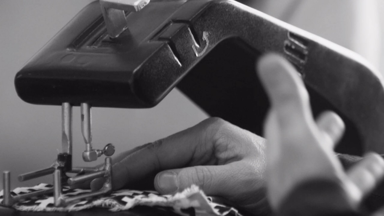 A person using a sewing machine 