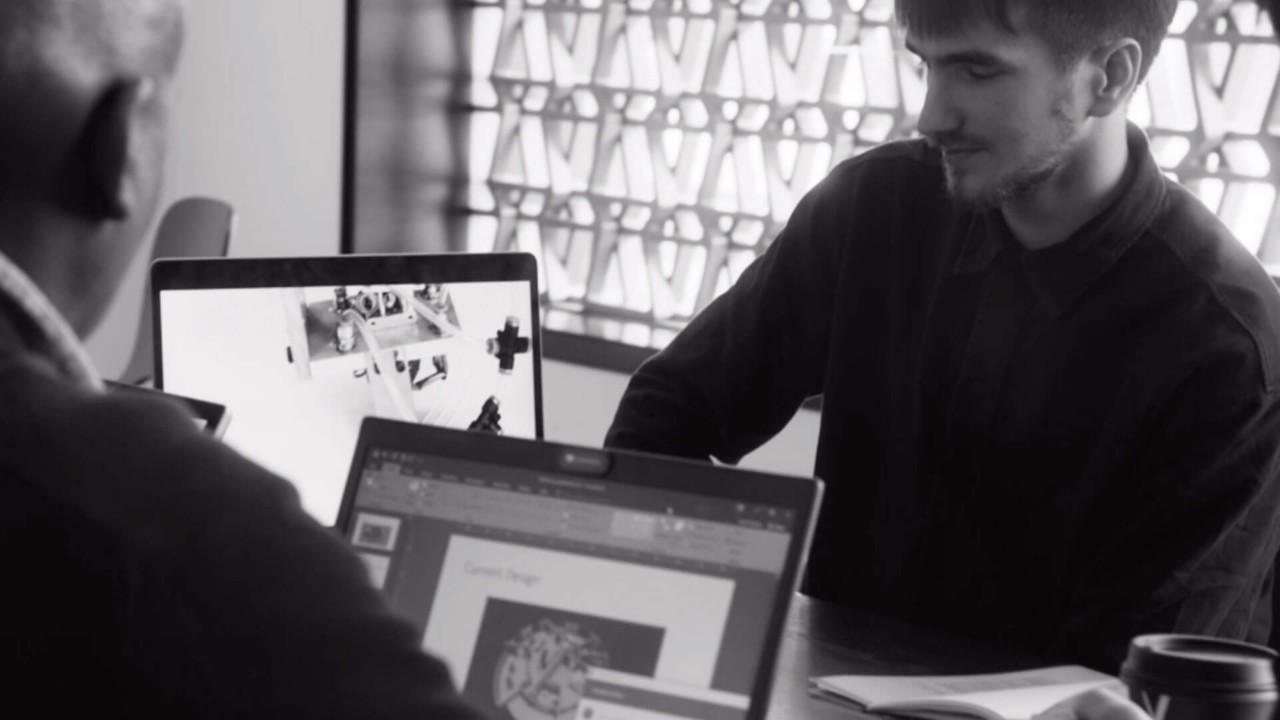 Two men working on laptops 