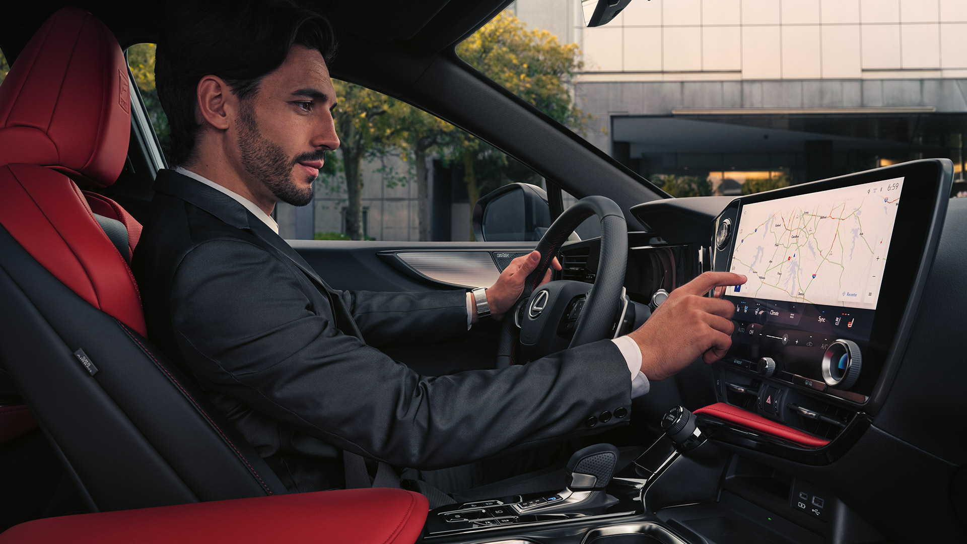 A man sitting in a Lexus using the touch screen display