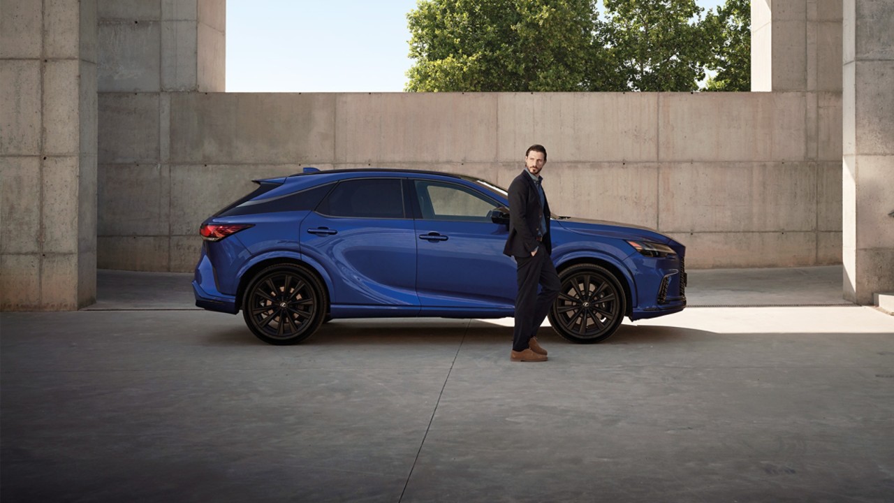 A man stood next to a Lexus RX