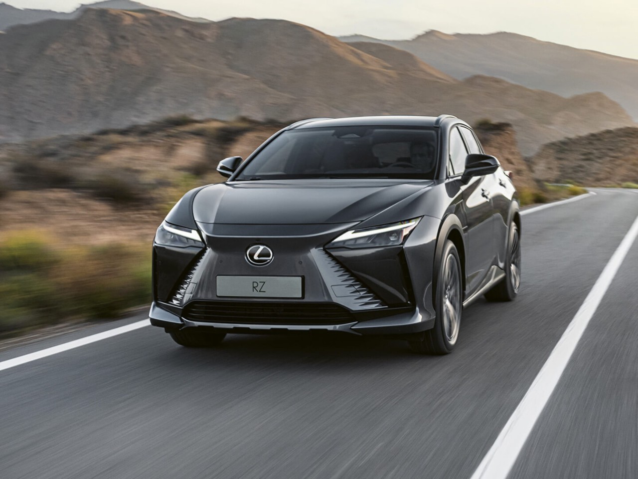 Lexus RZ driving in a rural location 