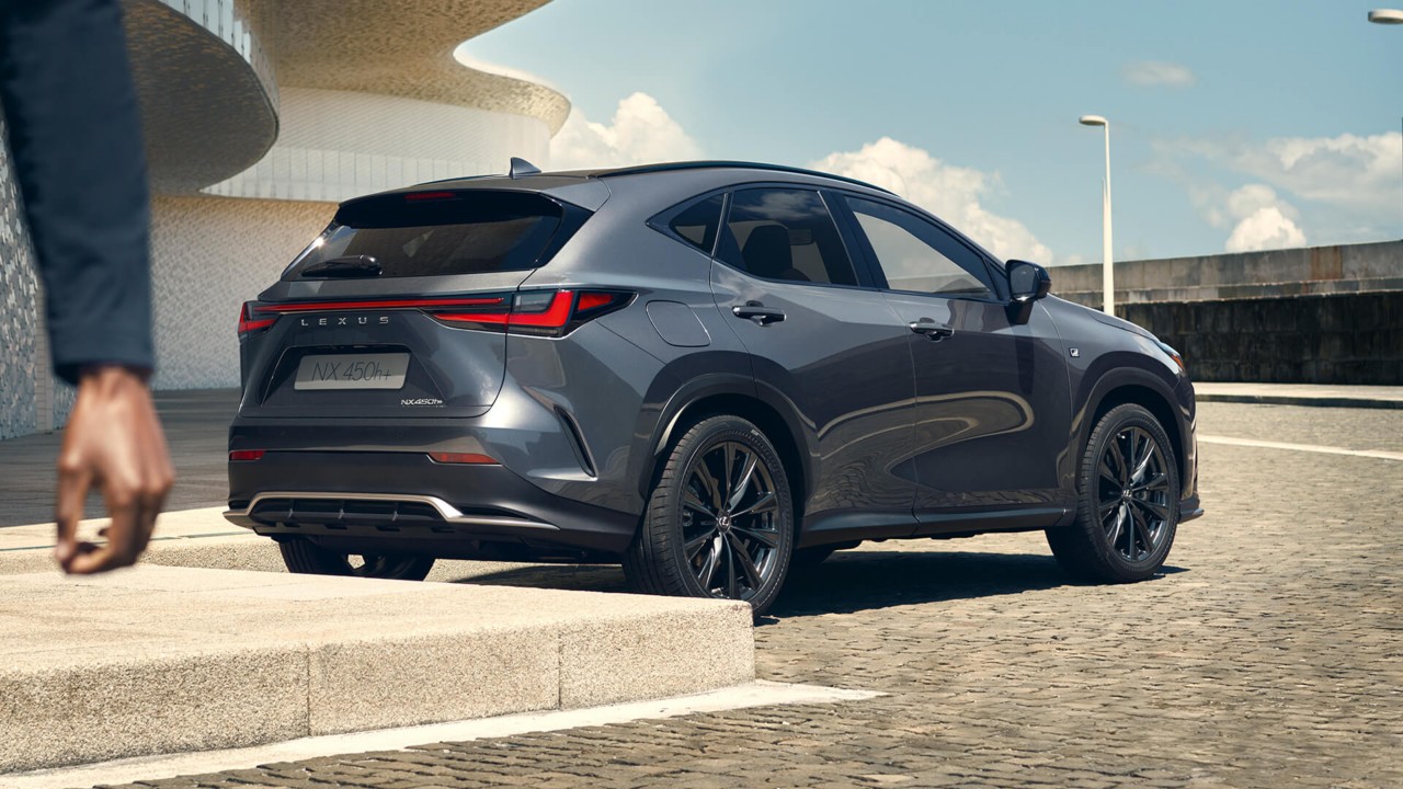 A man walking away from a Lexus NX 