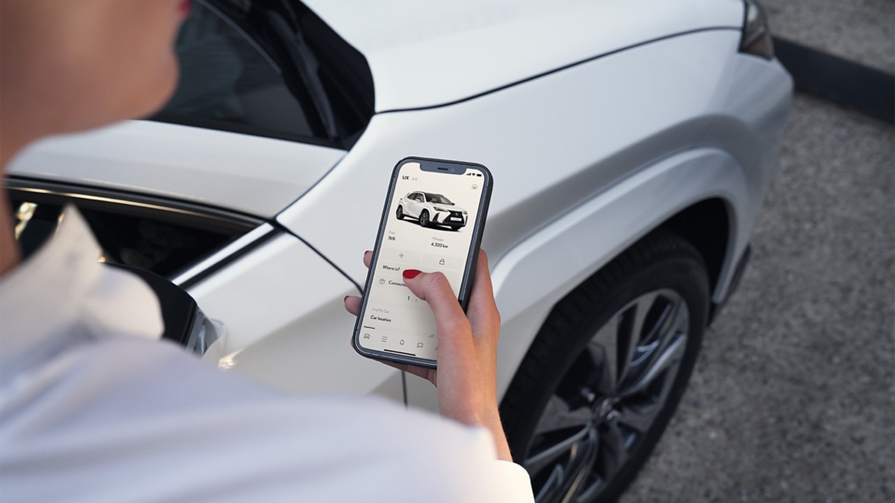 A man using his mobile phone to access the Lexus Link app